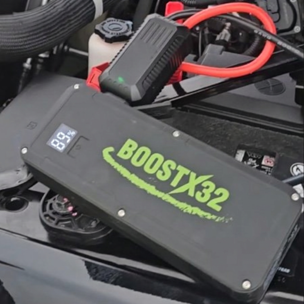 BoostX32 12V lithium jump starter connected to a RAM 2500 for a jump start